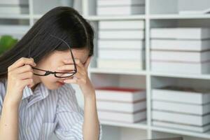 Concept Burnout Syndrome. Asian business Woman feels uncomfortable working. Which is caused by stress, accumulated from unsuccessful work And less resting body. Consult a specialist psychiatrist. photo