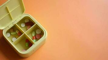 Close up of medical pills in a pill box on table video