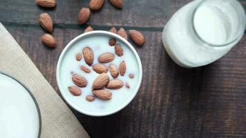 Almond nut in a bowl of milk on table video