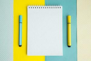 School supplies. Yellow and blue colors. Empty notebook. Flat lay composition. Space for text. photo