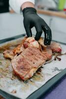 Beef steak with greens on a black plate. Steak with Basil cooked in the culinary master class. photo