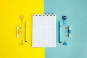 School supplies. Yellow and blue colors. Empty notebook. Flat lay composition. Space for text. photo