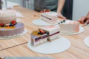 A slice of mousse cake in the cut. Making a cake at a culinary master class. Cooking at home, homemade food photo