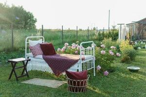 A wrought-iron bed on the street in the courtyard of a village house. photo