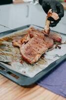 Beef steak with greens on a black plate. Steak with Basil cooked in the culinary master class photo