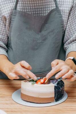 A piece of chocolate cake in the cut. Preparation of mousse cake ...