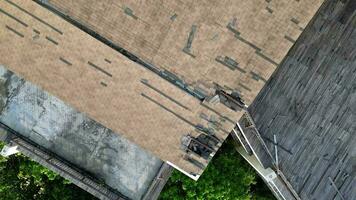 Aerial view look down broken rooftop building. Dilapidated structure video