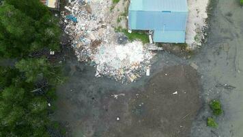 Aerial view look down rubbish dump near a house at rural area video