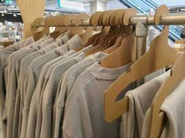 Casual clothes hanging on a rack in a store photo