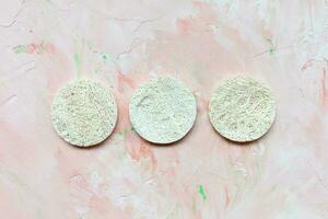 Three round loofah discs. Natural face sponges photo