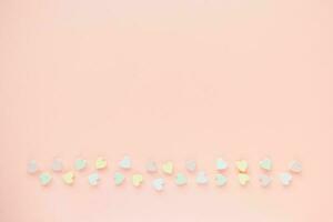 Romantic pastel pink backround with hearts decoration photo