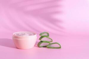 Cosmetic cream and aloe vera slices, copy space photo