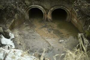 Pipes in ground. Draining water. Industrial waste. photo