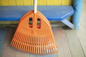 Orange broom. Cleaning tool. Garden tool. photo