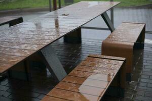 Wet table. Rain outside. Place to eat. photo