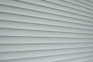 Blinds on window. Plastic shutters. Ribbed surface. photo
