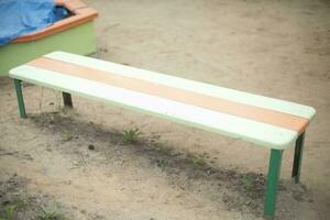 Bench on playground. Bench for relaxation. Furniture in yard. photo