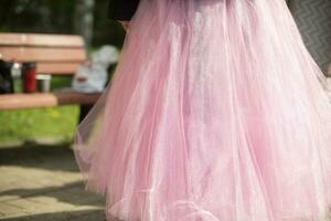 Pink dress. Skirt on girl. Pink fabric. photo