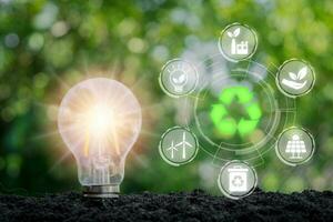 ESG concept of environmental, Light bulb on soil with ESG icon on virtual screen, social and corporate governance concept. photo
