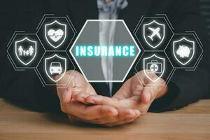 Insurance company client take out complete insurance concept, Person hand holding with  Insurance icon on virtual screen background on desk. photo