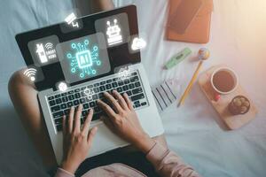 Artificial Intelligence AI, Person hand using laptop with holographic brain Artificial Intelligence icon from the screen, Internet of Things IoT concept. photo