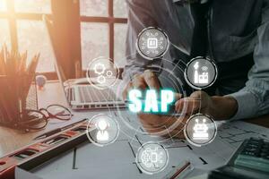 SAP - Business process automation software and management software, Person hand using smart phone with SAP icon on VR screen, ERP enterprise resources planning system concept on virtual screen. photo