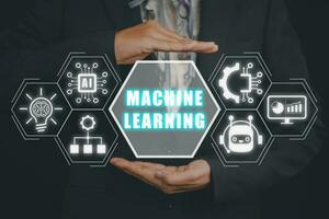 Machine learning concept, Businessman hand holding machine learning icon on virtual screen. photo