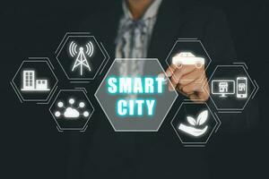 Smart city concept, Person hand touching smart city icon on virtual screen. photo