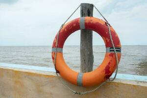 selectively focus on the red lifebuoy, used for emergency situations when someone is drowning photo