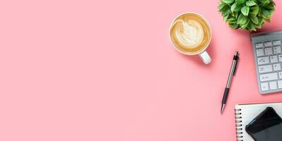 Top view, Pink office desk with keyboard, smart phone, Notebook, pen and Cup of coffee, copy space, Mock up. photo