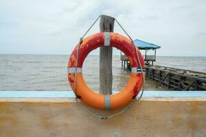 selectively focus on the red lifebuoy, used for emergency situations when someone is drowning photo