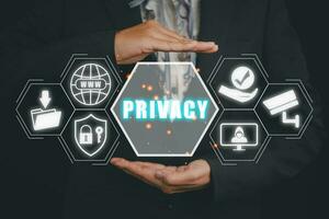 Privacy concept, Business person hand holding privacy icon on virtual screen. photo