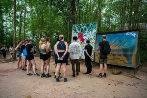 The Cu Chi tunnels. A guide demonstrating how a Vietcong hide into the Tunnel. It's used in Vietnam war. Famous tourist attraction in Vietnam. Stock photo