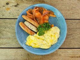 American breakfast top view on wooden table background. photo