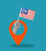 Art collage, Hand with Malaysian flag on blue background with navigation icon. photo