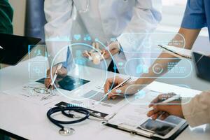 Medical technology network team meeting concept. Doctor hand working with smart phone modern digital tablet and laptop computer with graphics chart interface, with virtual icon photo