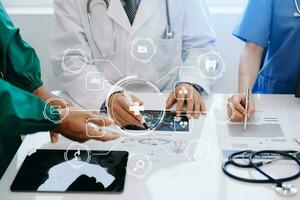 Medical technology network team meeting concept. Doctor hand working with smart phone modern digital tablet and laptop computer with graphics chart interface, with virtual icon photo