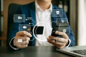 Close up of Hand using credit card and smartphone, laptop computer on wooden desk with VR icon chart graph diagram photo