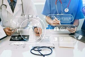 Medical technology network team meeting concept. Doctor hand working with smart phone modern digital tablet and laptop computer with graphics chart interface, with virtual icon photo