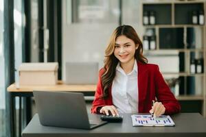 Woman freelancer is working her job on computer tablet and laptop Doing accounting analysis report real estate investment data, Financial at office photo