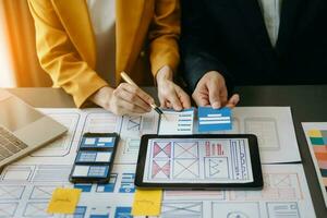 UX graphic designer planning application process development prototype wireframe for web smart phone. Creative digital development agency. photo