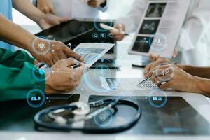 Medical technology network team meeting concept. Doctor hand working with smart phone modern digital tablet and laptop computer with graphics chart interface, with virtual icon photo