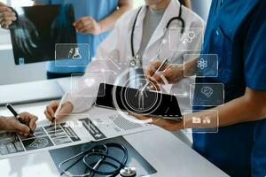 Medical technology network team meeting concept. Doctor hand working with smart phone modern digital tablet and laptop computer with graphics chart interface, with virtual icon photo