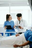 Doctors explaining the symptoms to a patient in a hospital or therapeutic treat client Professional medical service concept. photo