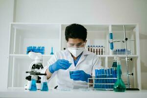 masculino biotecnólogo pruebas nuevo químico sustancias en un laboratorio. foto