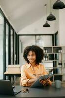 Business woman using tablet and laptop for doing math finance on an office desk, tax, report, accounting, statistics, and analytical research concept in office photo