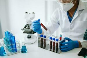 Male scientist researcher conducting an experiment in laboratory. photo