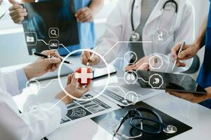 Medical technology network team meeting concept. Doctor hand working with smart phone modern digital tablet and laptop computer with graphics chart interface, with virtual icon photo