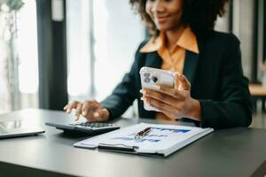 Close up of businesswoman or accountant hand typing laptop working to calculate on desk about cost at office. photo