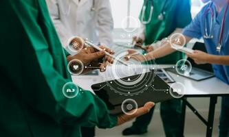 Medical technology network team meeting concept. Doctor hand working with smart phone modern digital tablet and laptop computer with graphics chart interface, with virtual icon photo